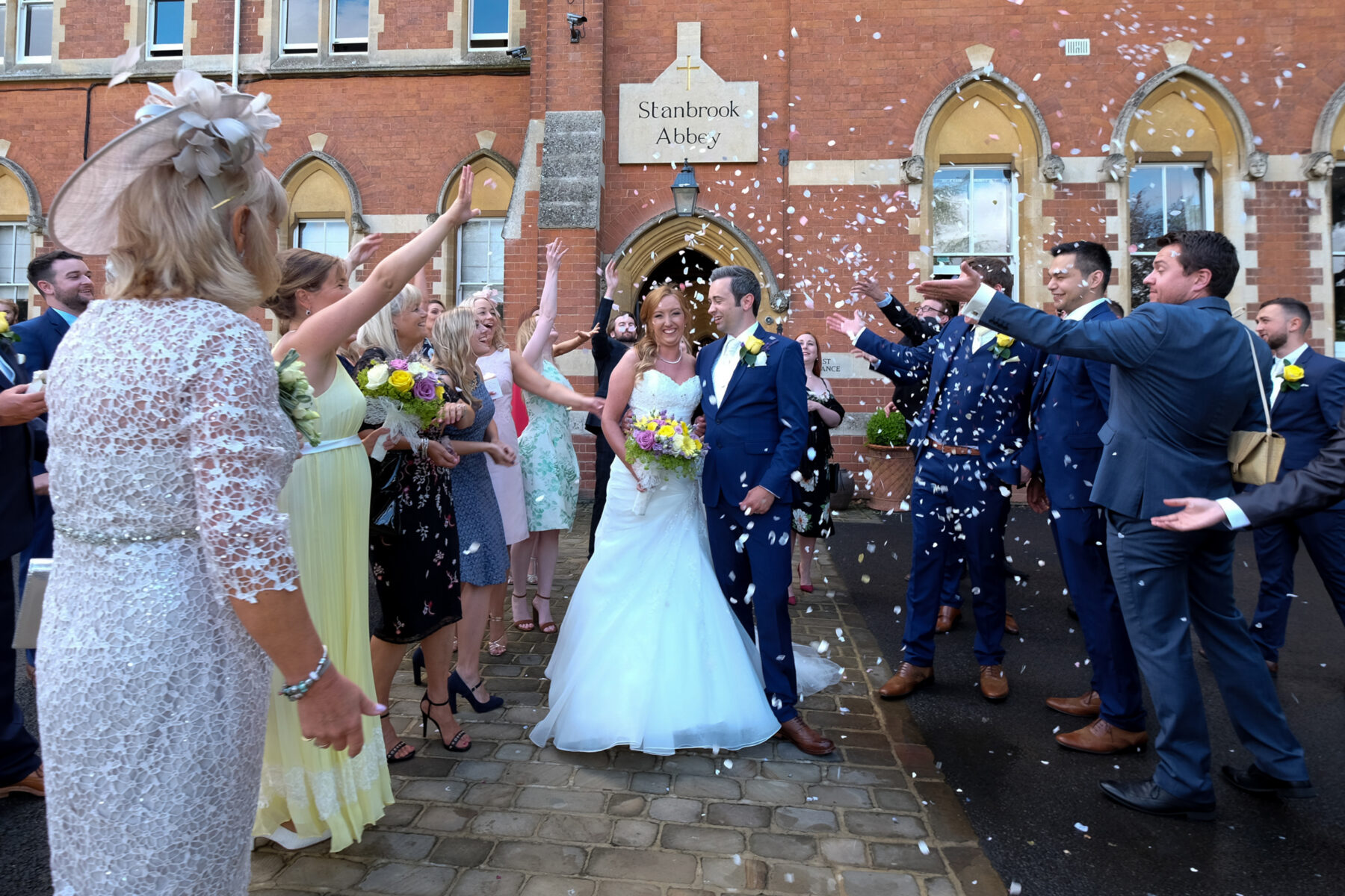 "Confetti moment outside Stanbrook Abbey entrance"